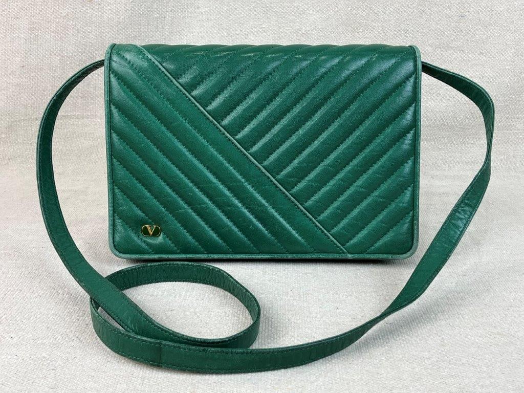 Valentino Garavani Quilted Leather Crossbody Bag: A sophisticated crossbody bag by Valentino Garavani, distinguished by its contemporary asymmetrical chevron quilted leather pattern. The sleek design is accented by a discreet gold-tone "V" logo
