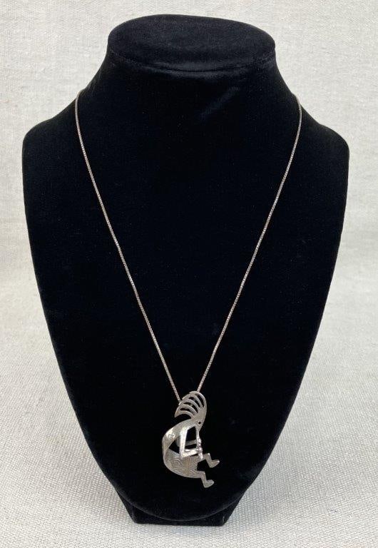 Sterling Silver Kokopelli Necklace: Sterling silver necklace featuring a dimensional figural Kokopelli pendant holding a flute, a symbol traditionally associated with fertility and the rain caller in Native American culture, suspended