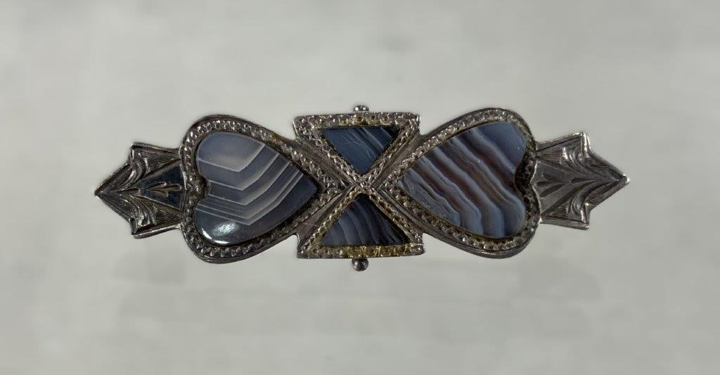Antique English Sterling Silver Montrose Agate Brooch: This antique English sterling silver brooch features beautifully hand-cut banded blue-grey Montrose agate stones arranged in a striking design, with two heart-shaped outer agate stones flanking a cent