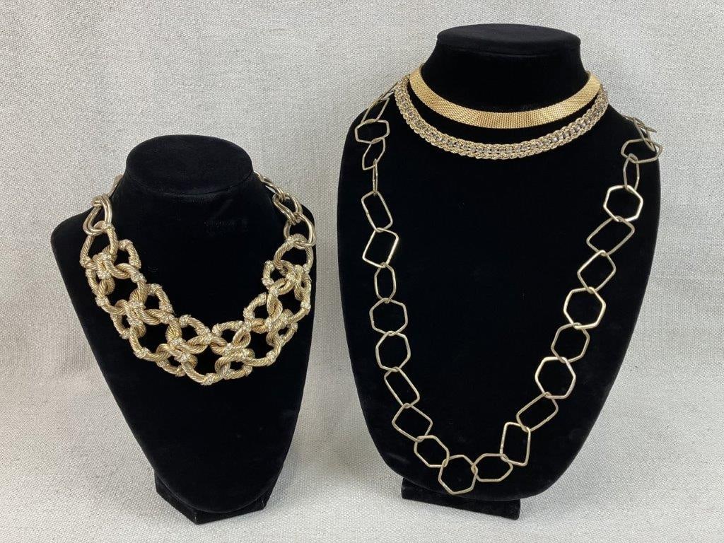 Gold-Tone Necklace Assortment Including Monet: A four-piece assortment of vintage gold-tone costume jewelry featuring a selection of classic designs, highlighted by a standout Monet collar necklace boasting an intricate mesh design. The collection