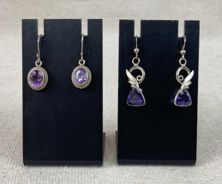 Two Pairs of Artisan Sterling Silver Dangle Earrings: A fine jewelry lot featuring two pairs of artisan dangle earrings crafted from sterling silver, both unmarked but tested for silver content, including one pair decorated with iridescent glass stones s