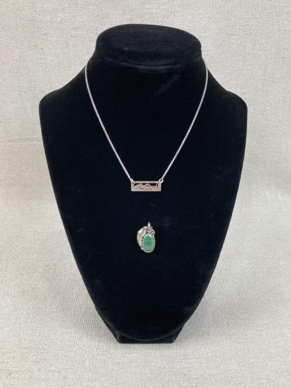 Sterling Silver Necklace and Malachite Pendant Pairing: This sterling silver jewelry lot features a standout artisan pendant showcasing an oval malachite cabochon surrounded by an intricate leafy design and a decorative rope border frame, beautifully paire