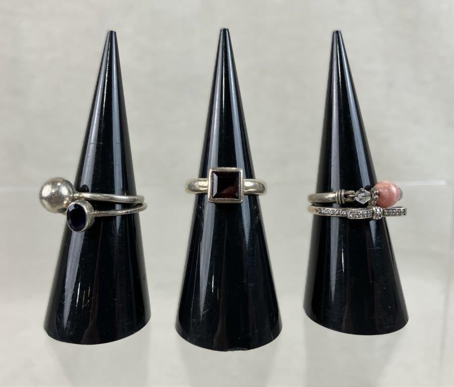 Sterling Silver Rings Including Avon and Pandora: This five-piece collection of sterling silver rings features a mix of designer favorites and minimalist styles. Highlights include a Pandora bow ring set with clear cubic zirconia along the band and b