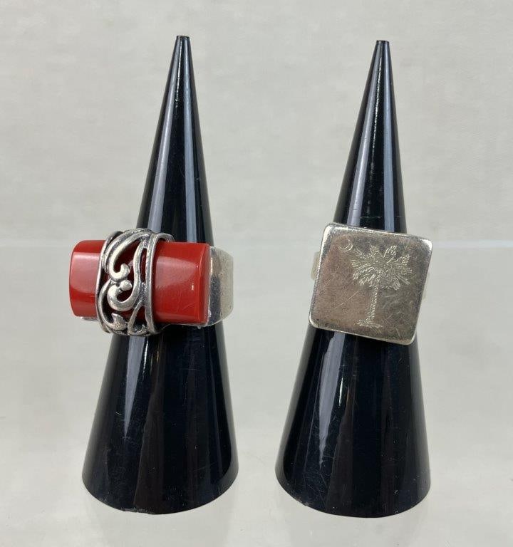 Sterling Silver Red Coral and South Carolina Rings: Two sterling silver rings offering a blend of intricate international design and local pride. The assortment features a Bali-style ring with a composite rectangular red coral block set in a wide band