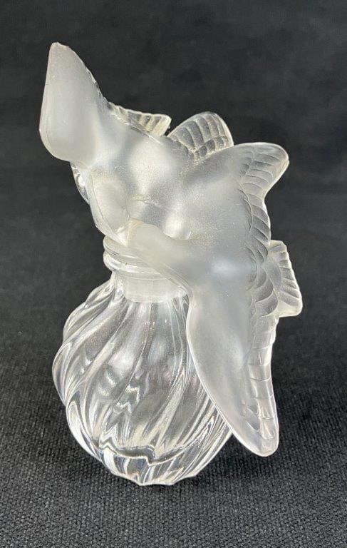 Lalique Art Glass Dove Perfume Bottle: Frosted and clear art glass perfume bottle by Lalique, designed for Nina Ricci L'Air du Temps perfume, featuring the iconic stopper with two kissing doves above a swirling molded glass body, signed