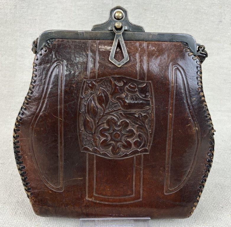 Art Nouveau Tooled Leather Purse: A remarkable early 20th-century accessory showcasing the organic, flowing aesthetics of the Art Nouveau movement. This purse features a central panel meticulously hand-tooled with an embossed floral