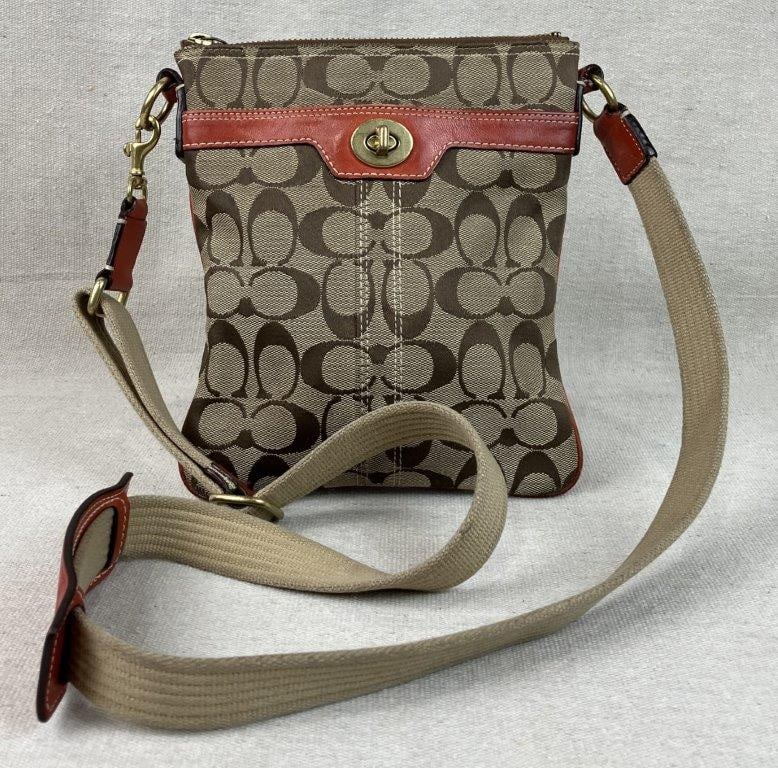 Coach Hampton Swingpack Crossbody Bag: A classic "Hampton" swingpack by Coach, featuring the iconic beige and brown signature jacquard canvas. The slender, vertical silhouette is elevated by vibrant red-orange leather trim and a durable,