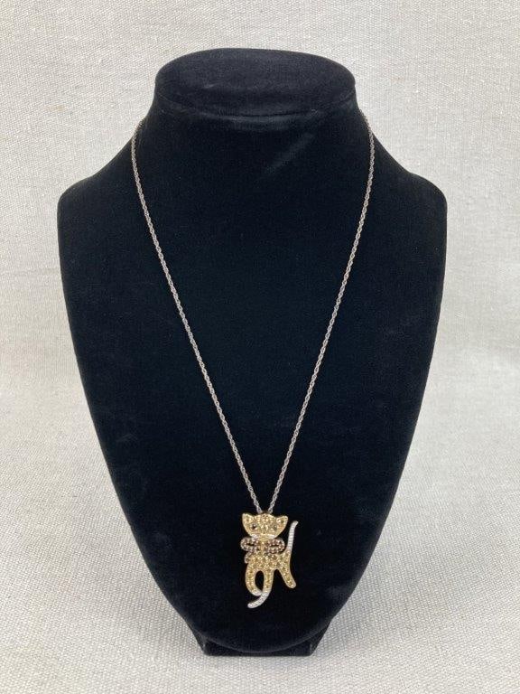 Sterling Silver Cat Necklace: This sterling silver necklace features a charming cat pendant adorned with gold vermeil accents. The whimsical design is beautifully set with shimmering clear cubic zirconia across the body and