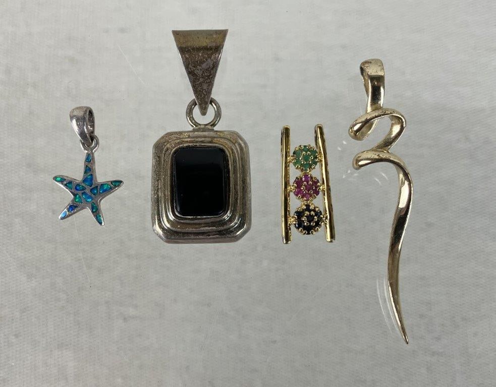 Sterling Silver Pendants: This four-piece assortment of sterling silver pendants showcases a diverse array of geometric, celestial, and vibrant gemstone designs. The assortment includes a stepped rectangular pendant set with