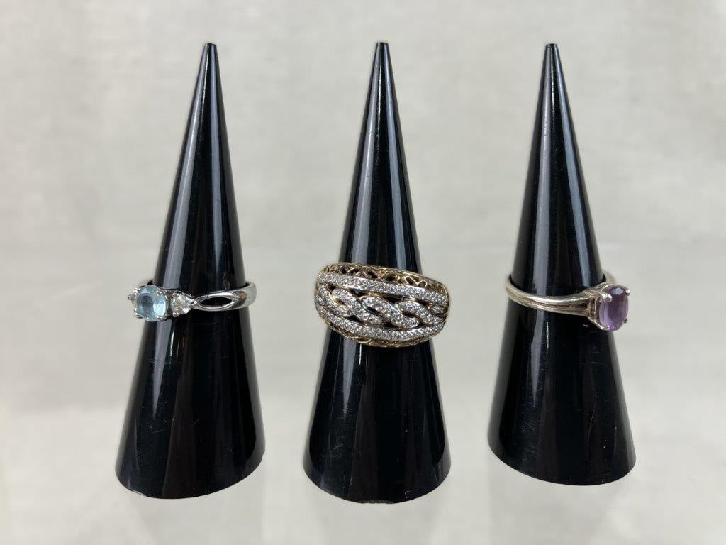 Sterling Silver Fashion Rings: Three sterling silver fashion rings including a stylish variety of textures, tones, and colorful gemstones. The assortment features a MEDA two-tone dome ring with a braided design and sparkling clear 