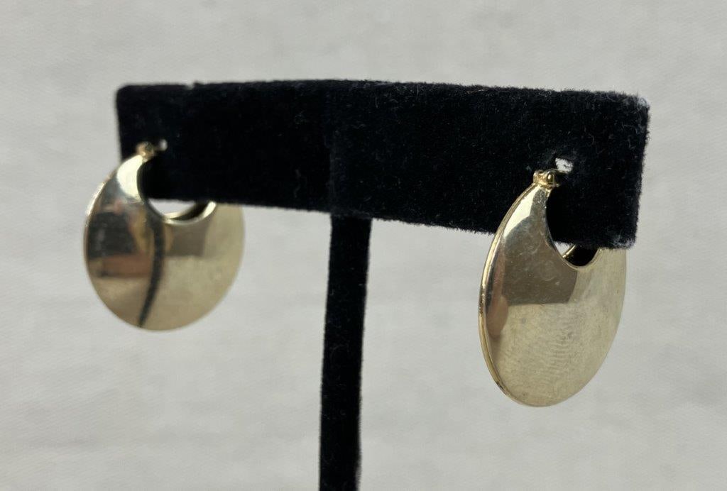 18K Gold Crescent Hoop Earrings: This pair of crescent hoop earrings is crafted from 18K gold and features a polished smooth surface with a secure latch-back closure. While unmarked, the metal has been tested as 18K gold. The