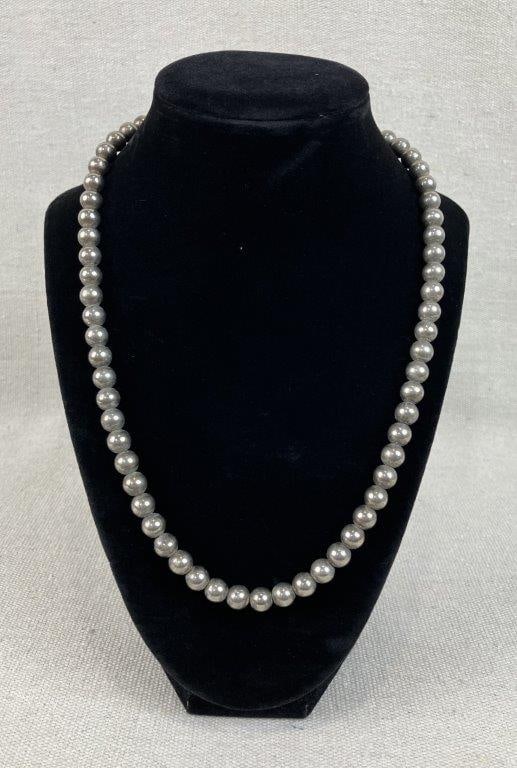 Sterling Silver Bead Necklace: This 24 in. necklace is composed of sterling silver sphere beads and features a secure lobster claw clasp. While unmarked, the metal has been tested as .925 sterling silver. The necklace measures