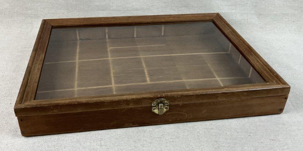Display Case: This wooden display case, ideal for showcasing jewelry or antique collections, features a classic wood exterior and a clear glass top with a convenient hinged lid with tiered molding. Measuring