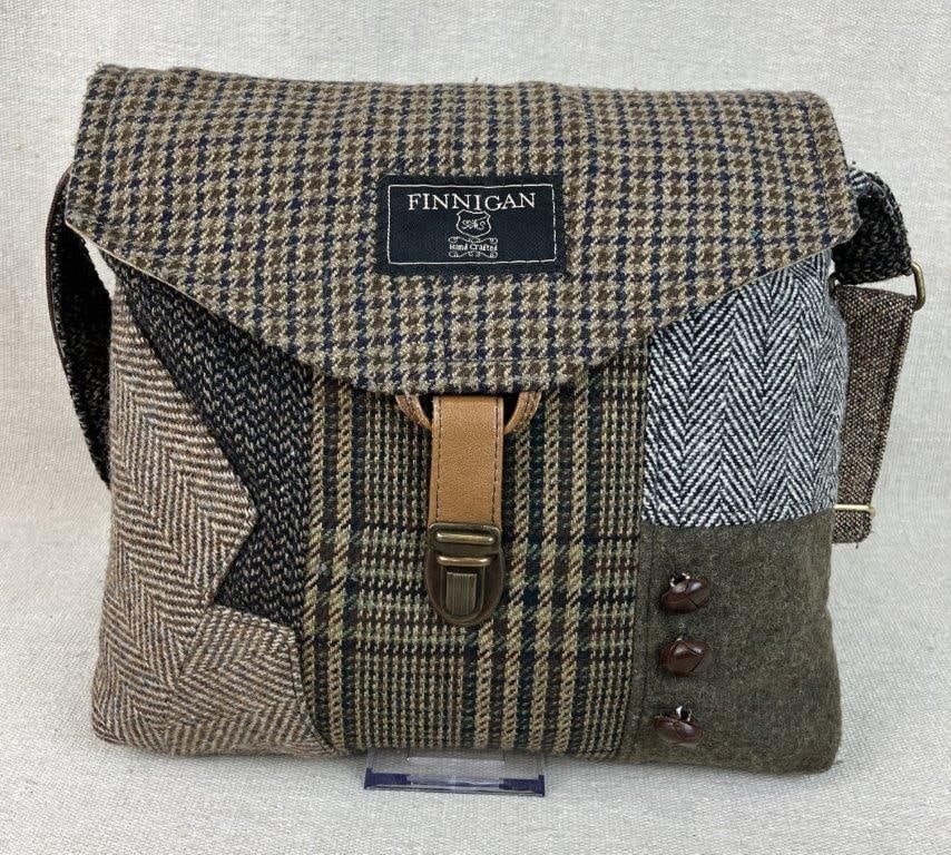 Finnigan Patchwork Messenger Bag: A unique, handcrafted "Finnigan" messenger bag designed by Terry Lischka of Sew Much Style, skillfully constructed from upcycled wool suit coats. The bag features an eclectic patchwork of traditional