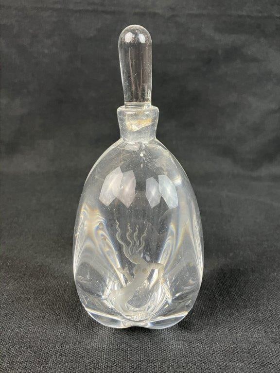 Orrefors Mermaid Art Glass Perfume Bottle: Etched art glass perfume bottle by Orrefors, featuring a finely detailed mermaid motif with elegant sculptural form, signed to the base. Measures approx. 5 3/4" H x 2 1/2" in diameter. Break to the