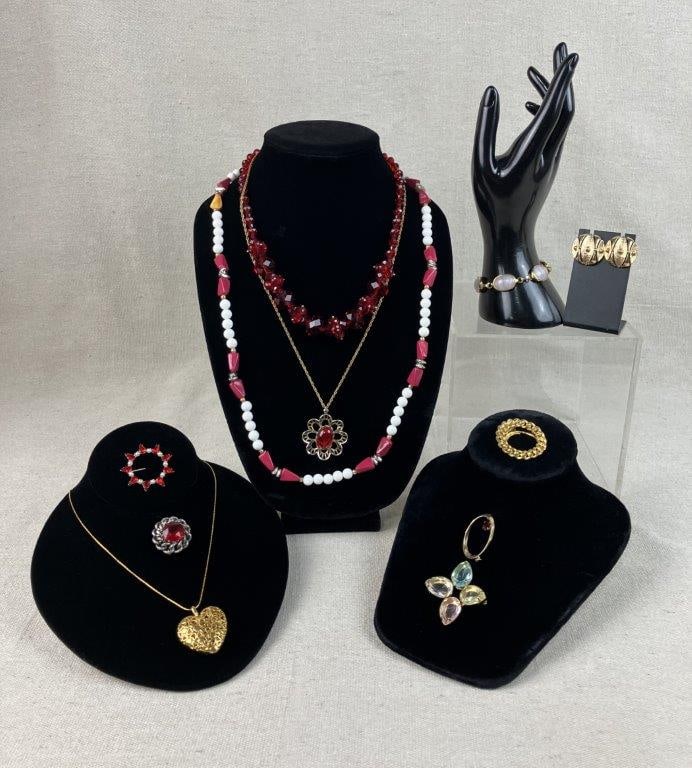 Assortment of Red and Gold-toned Jewelry Including Sarah Coventry: This eleven-piece collection of vintage costume jewelry features a bold combination of classic gold-tones and vibrant red accents. The set is highlighted by a pair of gold-tone Sarah Coventry earrings