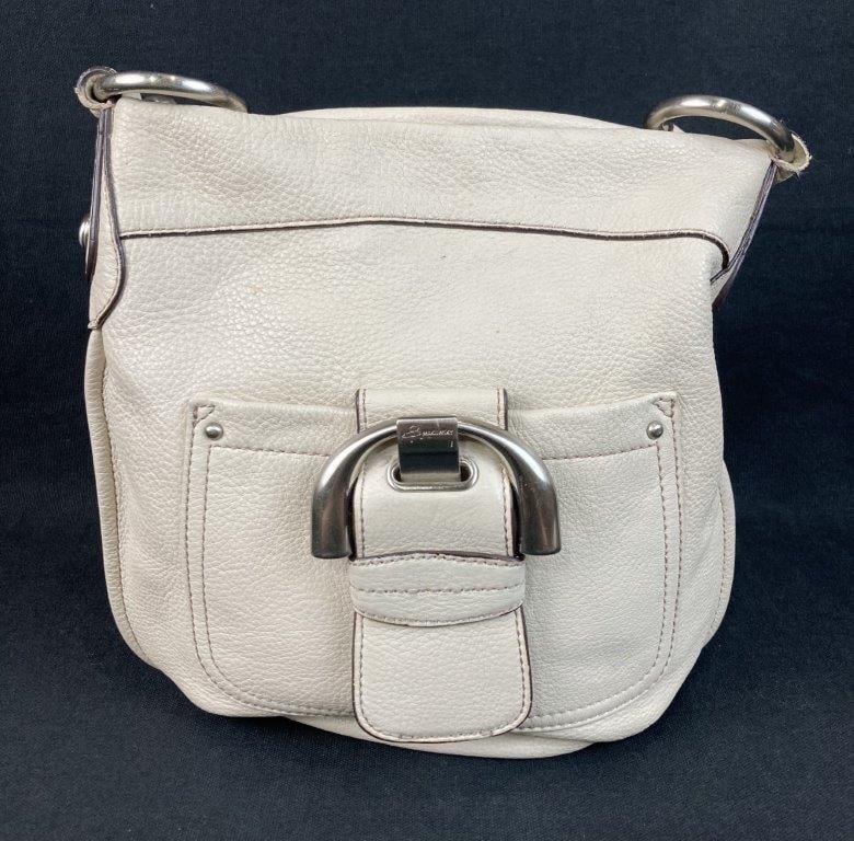 B. Makowsky Westbourne Crossbody Bag: A contemporary "Westbourne" crossbody bag by B. Makowsky, crafted from buttery-soft, cream-colored pebbled leather. The design features a slim, hobo-style silhouette anchored by a signature chunky