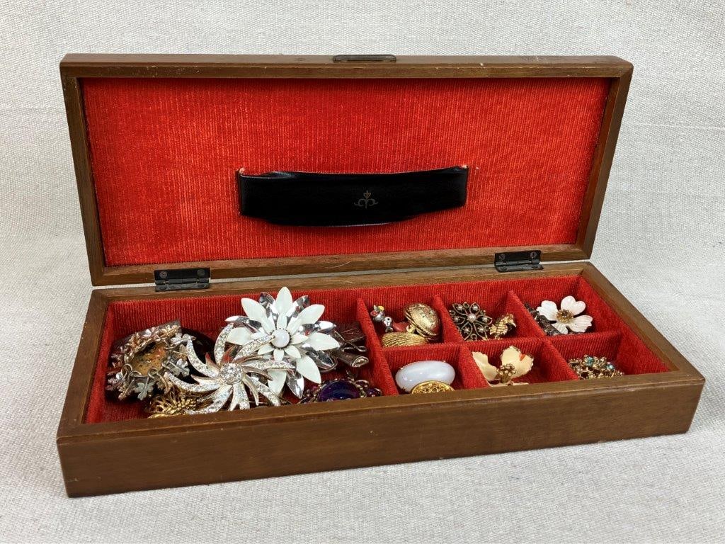 Assortment of Vintage Brooches with Ship Themed Jewelry Box: This twenty-four-piece brooch collection features a wide variety of vintage styles, including notable examples by Sarah Coventry. Highlights include a Sarah Coventry silver-tone floral brooch with