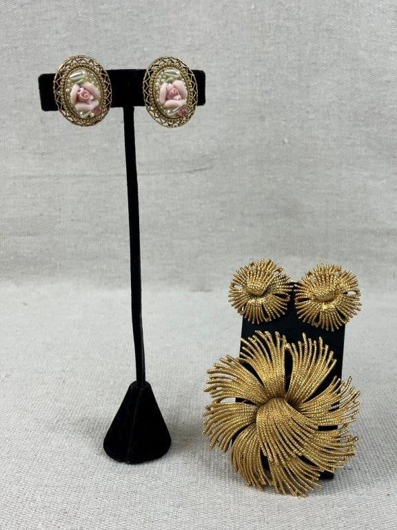 Gold-tone Monet Brooch and Earrings: This vintage collection features a Monet "Cordelia" statement brooch showcasing a wiry starburst floral design, accompanied by two matching earrings. Also included is a separate pair of porcelain rose