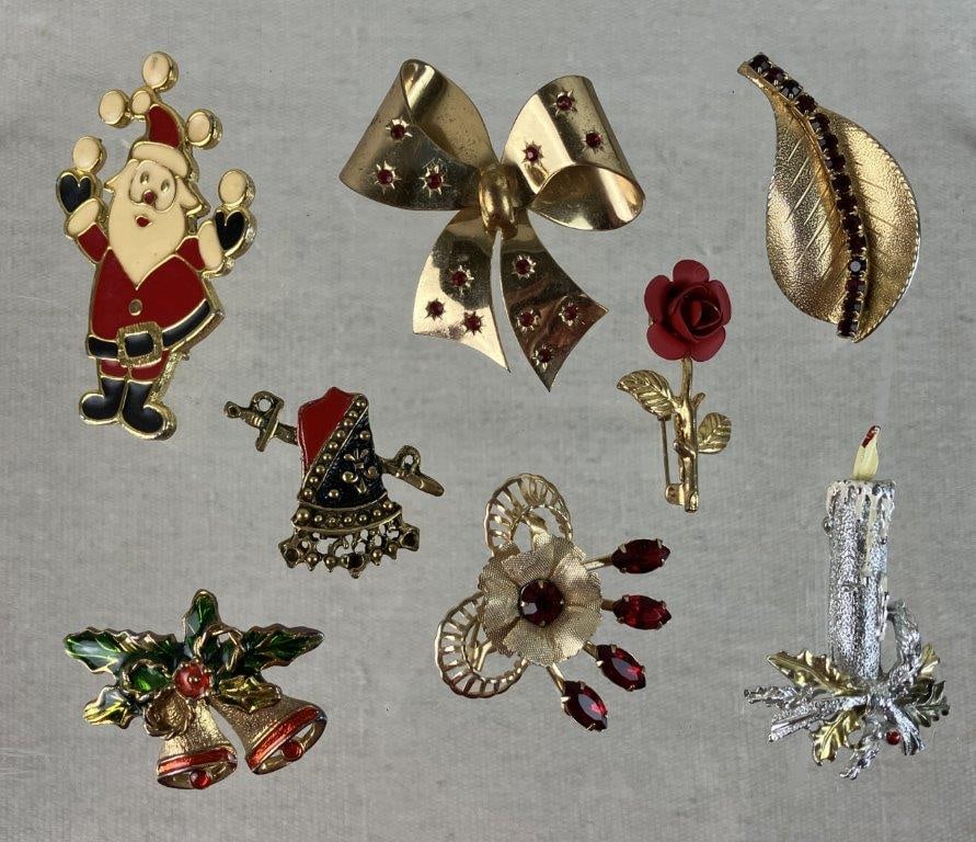 Assortment of Christmas and Plant Brooches: This eight-piece brooch collection combines festive holiday spirit with timeless botanical designs. The set features four Christmas-themed pieces, including a jolly Santa Claus and a gold-tone bow emb
