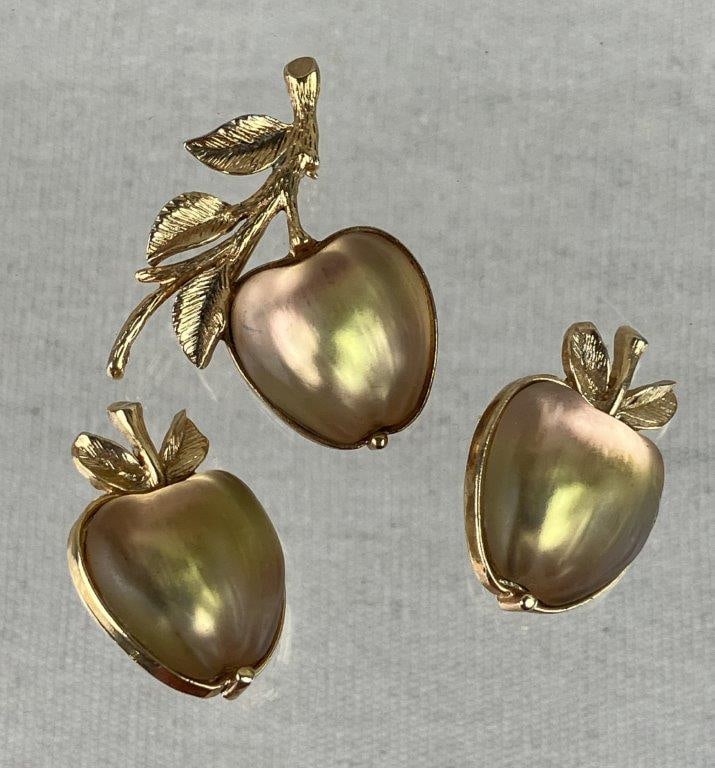 Sarah Coventry Gold-tone Apple Brooch and Clip-On Earrings, 1970: Vintage costume jewelry set by Sarah Coventry from the 1970 "Delicious" collection, including a brooch and matching clip-on earrings, each featuring a luminous frosted iridescent apple form center