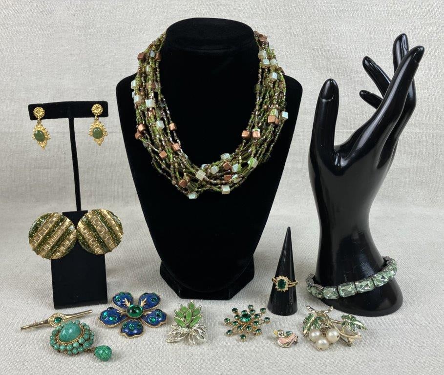 Green and Gold-toned Jewelry Assortment Including Hobe: A collection of twelve vintage costume jewelry items featuring a lush palette of forest greens and radiant gold tones. A primary highlight is a pair of gold-tone Hobé earrings showcasing a