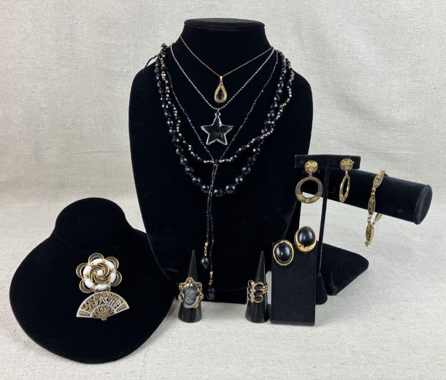 Assortment of Gold and Dark-tone Jewelry: This twelve-piece collection of vintage costume jewelry features a sophisticated mix of golden hues and deep, dark accents. The set is highlighted by an ornate gold-tone fan brooch showcasing