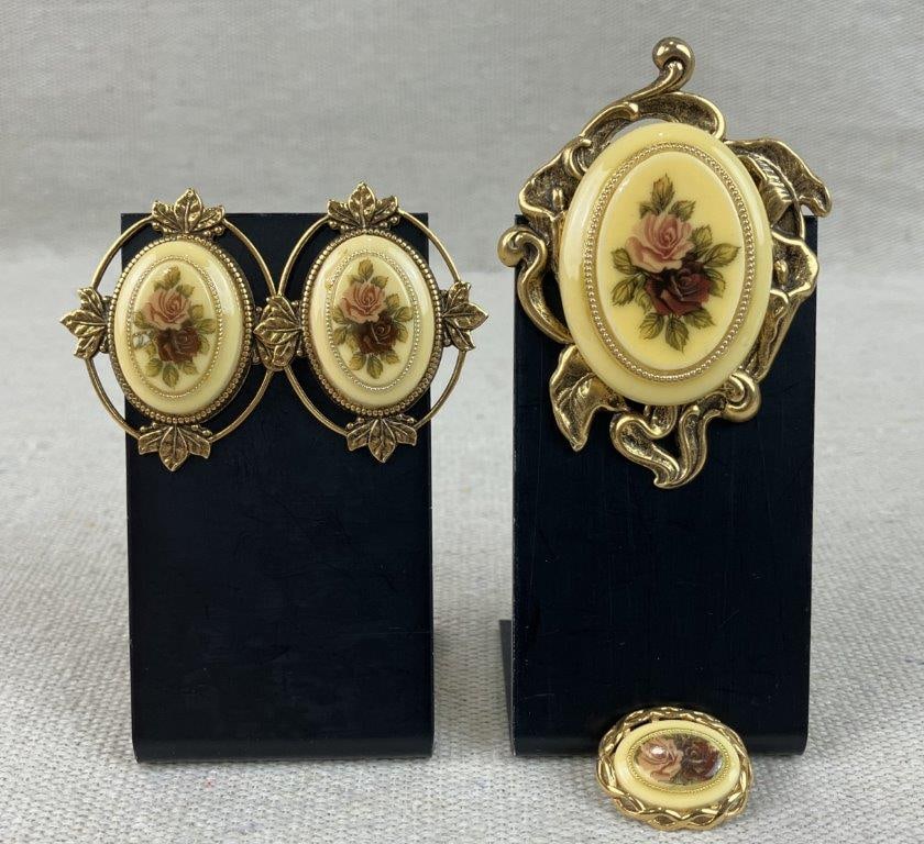 Vintage Cameo Rose Brooch and Earrings: This vintage jewelry set features molded acrylic smooth oval inserts with transfer-printed art depicting pink and burgundy-toned roses with green foliage. The gold-toned metal bases feature open-work