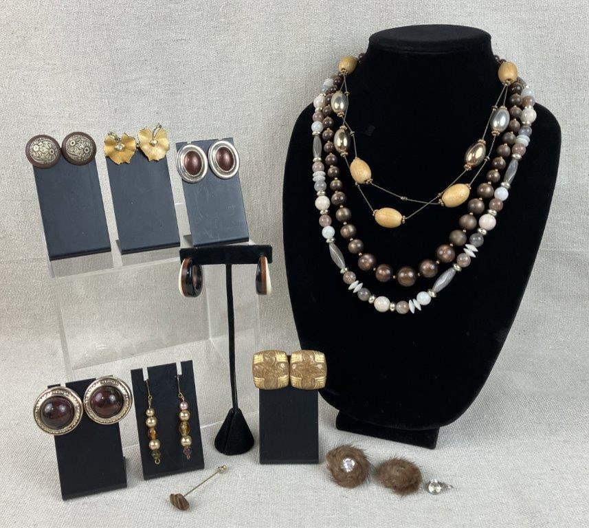 Assortment of Costume Jewelry Including Coro: Group of eleven pieces of vintage costume jewelry in brown tones, including examples of beads, enamel, fur, and wood in both gold tone and silver tone settings, featuring a standout tiger's eye style 