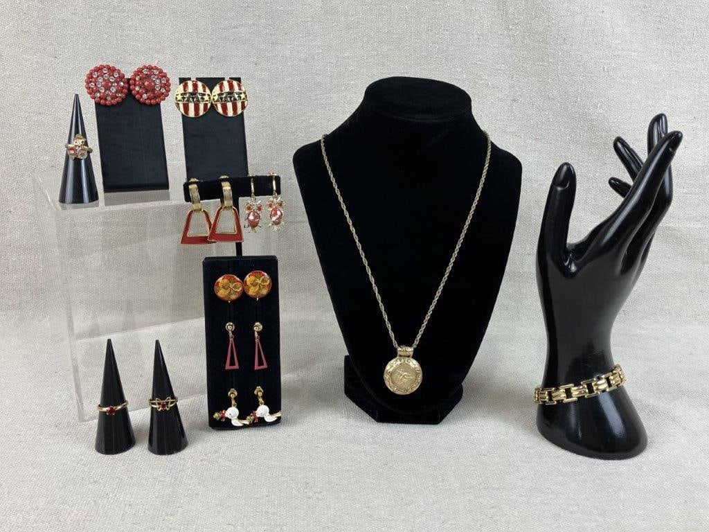 Assortment of Vintage Gold and Red-toned Jewelry: This twelve-piece collection of vintage costume jewelry features a mix of patriotic themes and classic golden accents. The set includes a pair of round gold-tone earrings with a resin American flag
