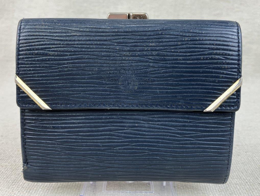 Valentino Garavani Epi Leather Wallet: A sophisticated bi-fold wallet by Valentino Garavani, crafted from durable navy blue epi-style textured leather. The design is accented with protective gold-tone metal corner reinforcements and