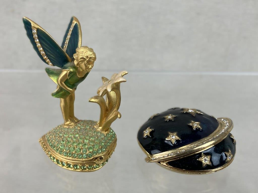 Vintage Estee Lauder Perfume Compacts: Two vintage solid perfume compacts by Estee Lauder with beautiful enamel work, each retaining solid fragrance. One designed in the form of a fairy with flower motif, and the other modeled as Saturn