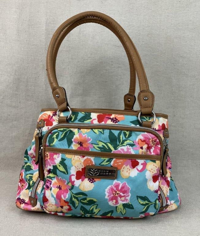 Lily Bloom Floral Shoulder Bag: A vibrant shoulder bag from Lily Bloom featuring the signature "Karma" floral pattern set against a bright turquoise blue background, complemented by tan and brown trim. Designed for high