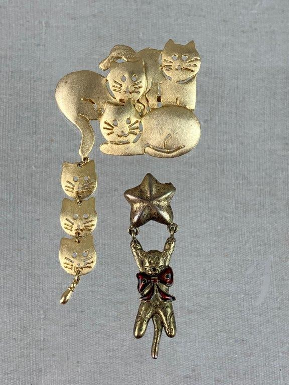 Gold-Tone Cat Brooches: This pair of gold-tone cat brooches offers two distinctly charming takes on feline-themed jewelry, perfect for any enthusiast of vintage whimsical accessories. The first piece, crafted by Ultra