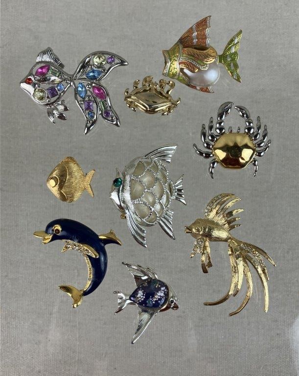 Collection of Sea Animal Brooches: This nine-piece collection of maritime-inspired jewelry features a delightful variety of aquatic creatures in diverse finishes. A centerpiece of the group is a gold-tone fish crafted by Trifari. The