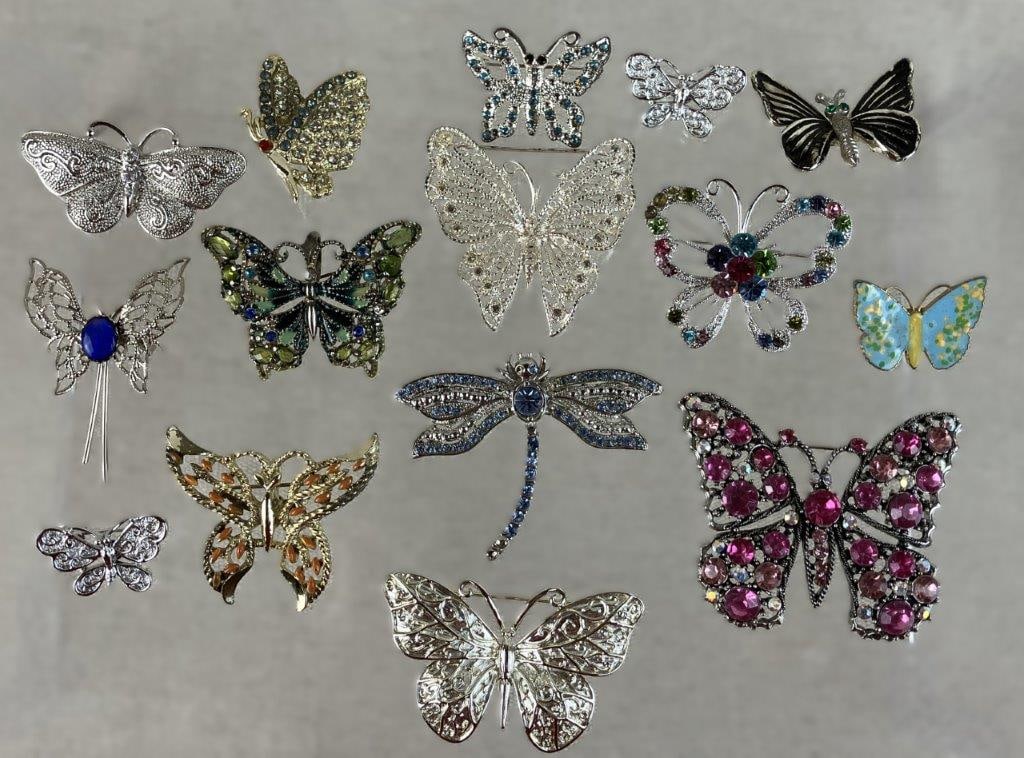 Collection of Butterfly Brooches: This fifteen-piece jewelry collection captures a delicate, garden-inspired aesthetic, featuring fourteen butterfly-motif brooches and a single shimmering dragonfly. Many of the butterflies are