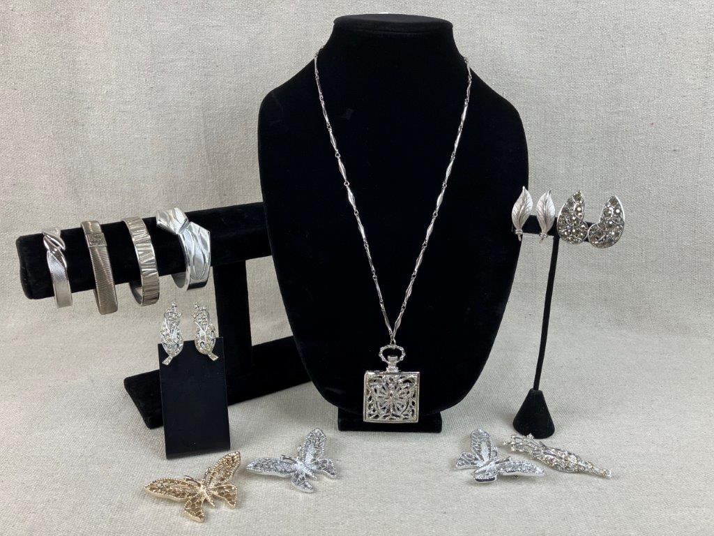 Assortment of Silver-tone Jewelry Including Sarah Coventry: This twelve-piece collection of vintage jewelry is headlined by several notable designer-signed accessories. The set features three Sarah Coventry Butterfly brooches, including two in silver-tone and