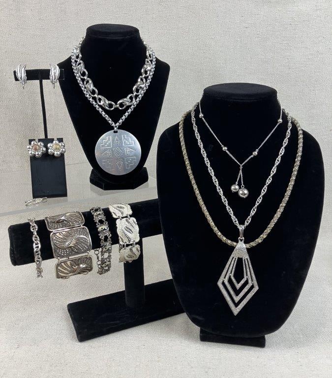 Silver-tone Necklaces and Bracelets Including Monet: This twelve-piece collection of vintage costume jewelry features a versatile selection of necklaces, bracelets, and earrings. Highlights include a pair of silver-tone double feather motif earrings by 
