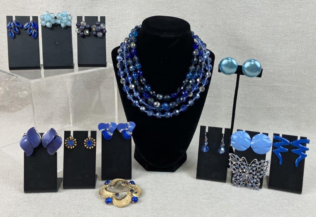Assortment of Vintage Blue-toned Jewelry Including Monet and Bobley: A fourteen-piece collection of vintage costume jewelry featuring a diverse range of styles in vibrant shades of blue. Highlights include a pair of moonglow blue Lucite earrings featuring two S-curve L
