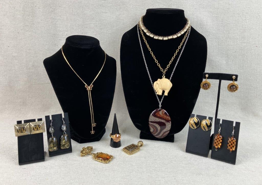 Assortment of Vintage Gold-tone Jewelry: This twelve-piece collection of vintage gold-tone costume jewelry features a playful mix of animal prints, organic shapes, and classic scrollwork. Highlights include a gold-tone pendant with a