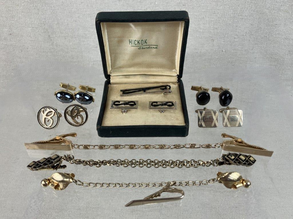 Assortment of Vintage Gold-tone Cufflinks and Tie Clips: A vintage collection of accessories featuring five pairs of cufflinks, five sweater clips, and two tie clips, highlighted by a silver-tone Hickok set with open-work detailing and a black enamel loop d