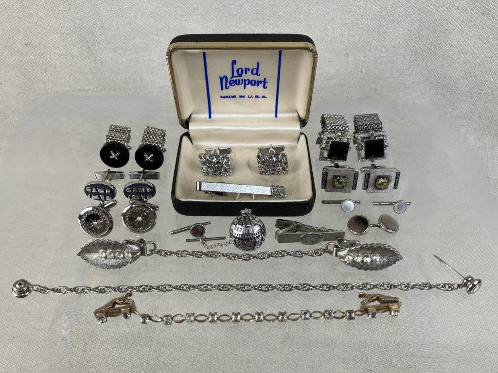 Assortment of Silver-tone Men's Tie Clips and Cuff Links: A handsome collection vintage men's tie clips and cufflinks includes six pairs of cufflinks, five tie clips, and four tie tacks, featuring a Lord New Port silver-tone set with two square-shaped