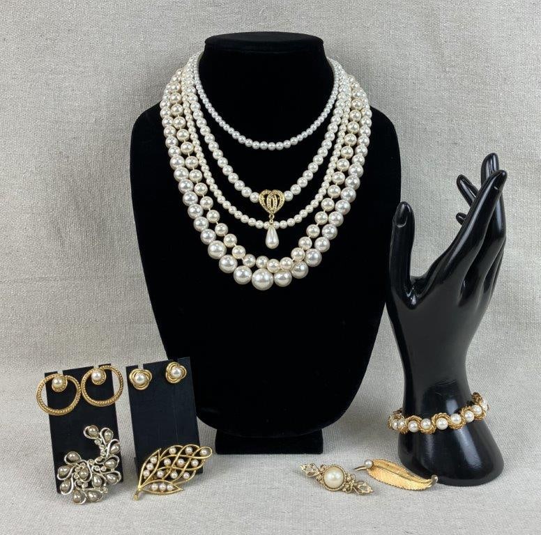 Vintage Faux Pearl Jewelry Assortment: This twelve-piece assortment of vintage costume jewelry features faux pearls and gold-tone settings throughout, consisting of five necklaces, one bracelet, four brooches, and two earrings. A