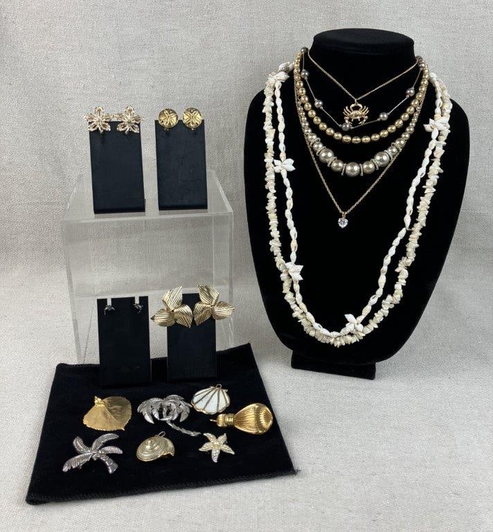 Assortment of Gold and Silver-Tone Jewelry: This jewelry assortment features a coastal and natural theme, blending gold and silver-tone finishes with organic elements. The collection is highlighted by a Sundial seashell with gold-tone