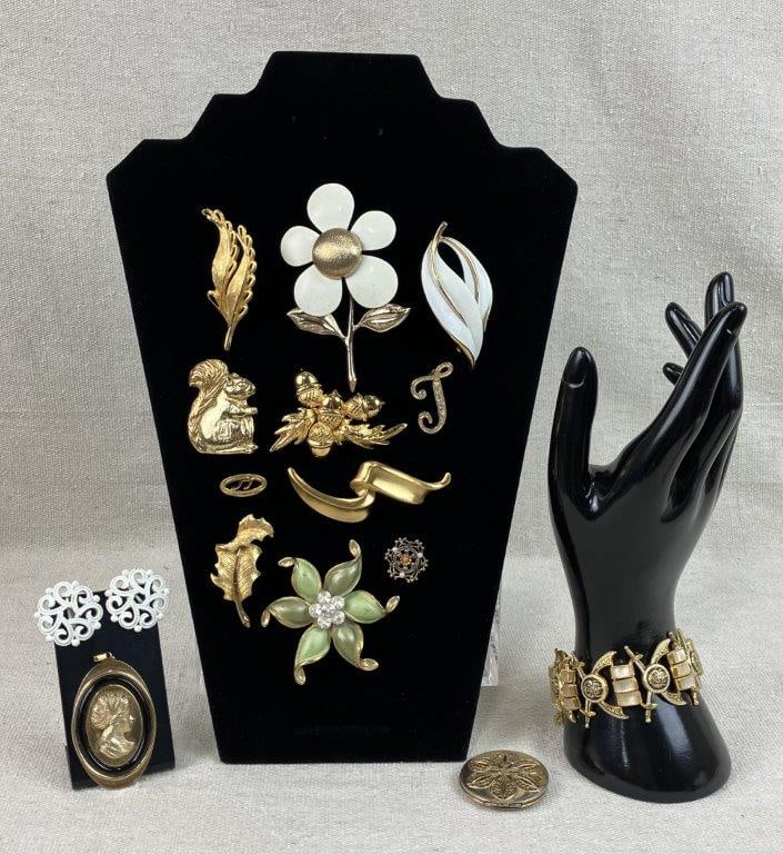 Gold-Tone Jewelry Assortment Including Sarah Coventry and Monet: This fifteen-piece collection of vintage gold-tone costume jewelry features a curated mix of botanical and figural designs, including a leaf brooch by Mamselle, a charming squirrel brooch, a Sarah