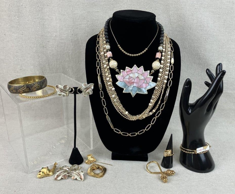 Costume Jewelry Assortment Including Monet and Sarah Coventry: This fifteen-piece collection of vintage costume jewelry features a Sarah Coventry multi-strand gold-tone chain necklace and a unique gold-tone snail motif brooch embellished with a multitude of