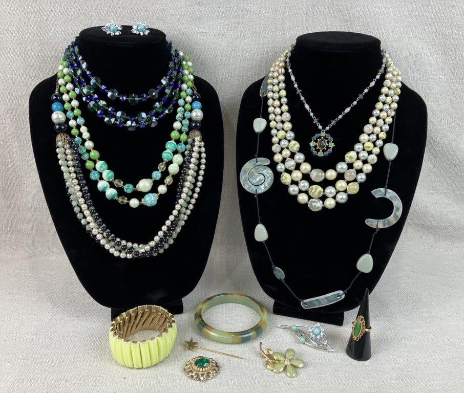 Assortment of Costume Jewelry Including Vogue, Sarah Coventry, and Coro: This fourteen-piece collection of vintage costume jewelry showcases a vibrant cool-toned palette and intricate metalwork from iconic designers. Featured items include a gold-tone Vogue ring with an ov