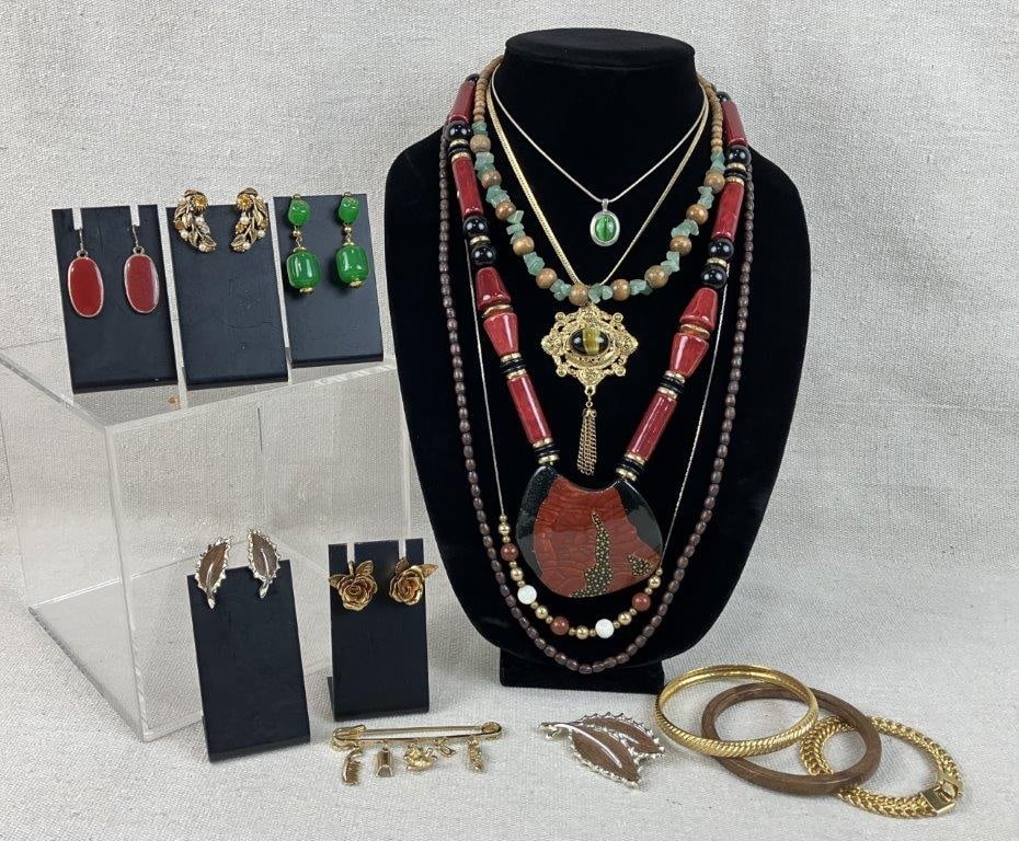 Costume Jewelry Assortment Including American Showcase and Sarah Coventry: A sixteen-piece collection of vintage costume jewelry featuring a diverse array of global and organic styles. Highlights include an American Showcase necklace with an ornate gold-tone pendant set with