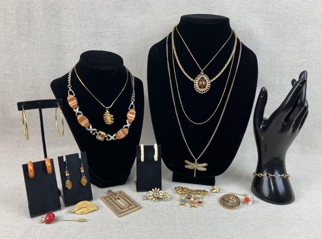 Gold-Tone Jewelry Assortment Including Napier and Sarah Coventry: This eighteen-piece collection of vintage costume jewelry features a curated mix of botanical and ornate designs, including a gold-tone Napier necklace with a delicate chain and pinecone-form pendant