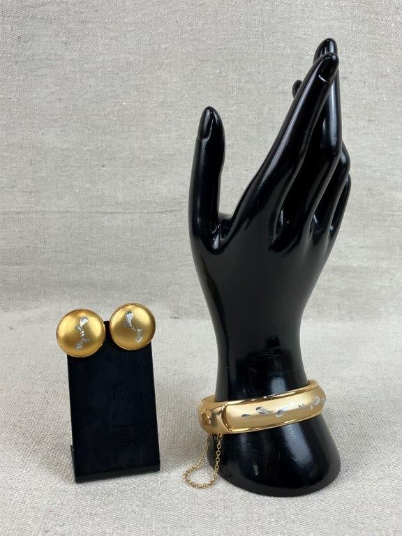 Vintage Gold-tone Etched Bangle Bracelet and Earrings: This vintage gold-tone jewelry set includes a bangle bracelet featuring a simple etched leaf design and a security chain, paired with two round clip-on earrings with a simple etched knot design, with